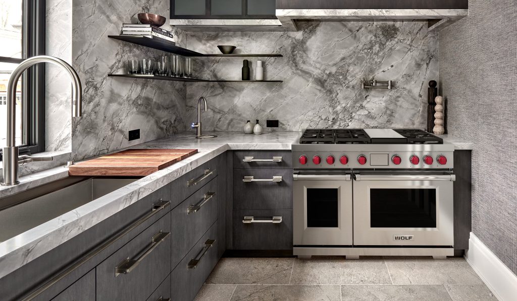 Dual fuel range repair on a stainless Wolf 48-inch double oven model with red knobs, set against marble in a luxury Orange County kitchen.