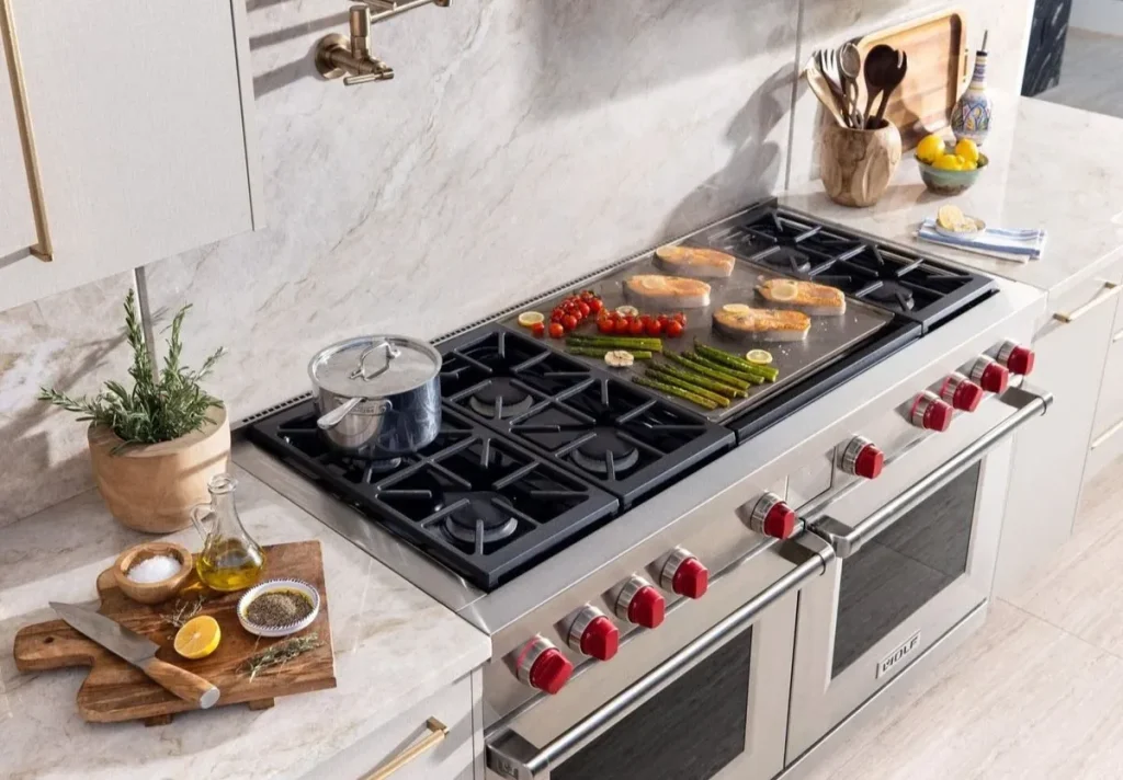 Wolf gas range with griddle and red control knobs