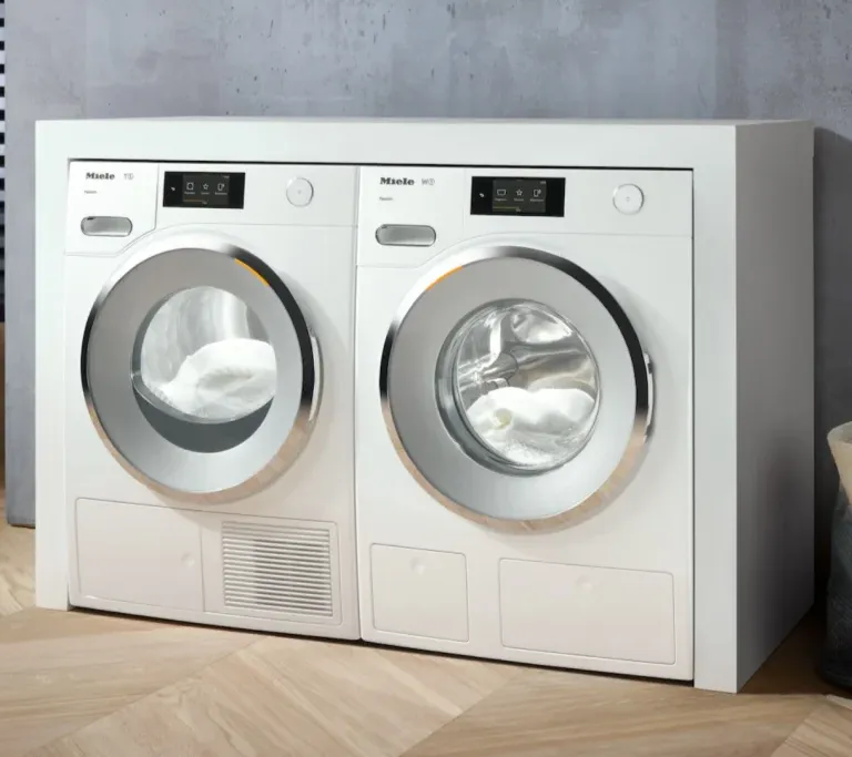 Miele white front-load washer and dryer in a laundry room